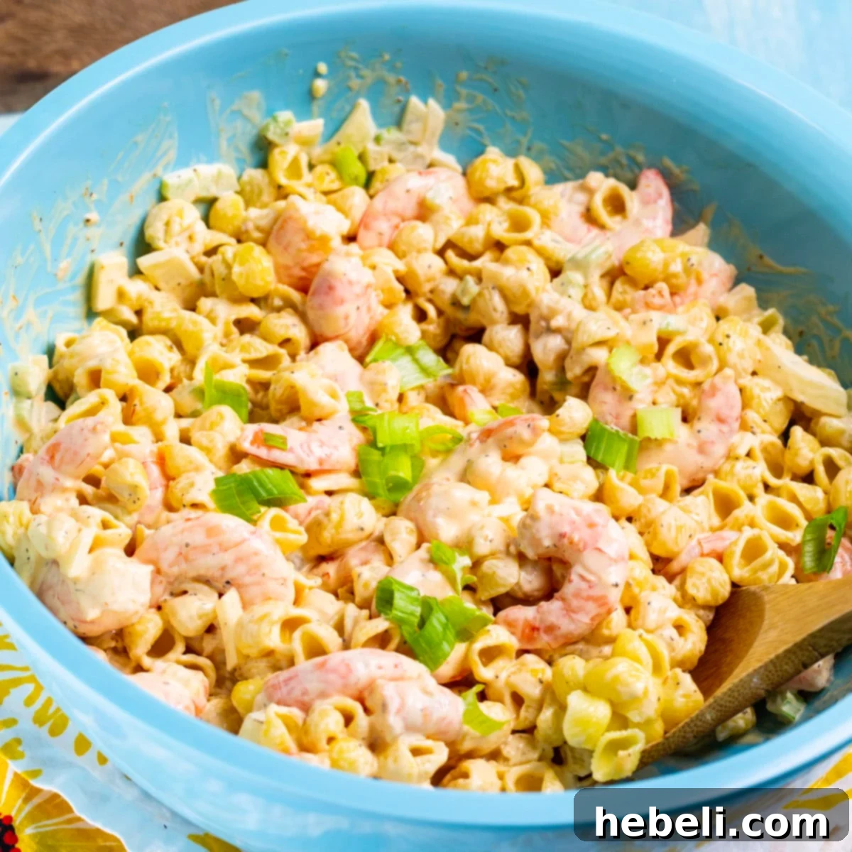 Tangy Shrimp Pasta Salad in a vibrant blue mixing bowl, ready to be served.