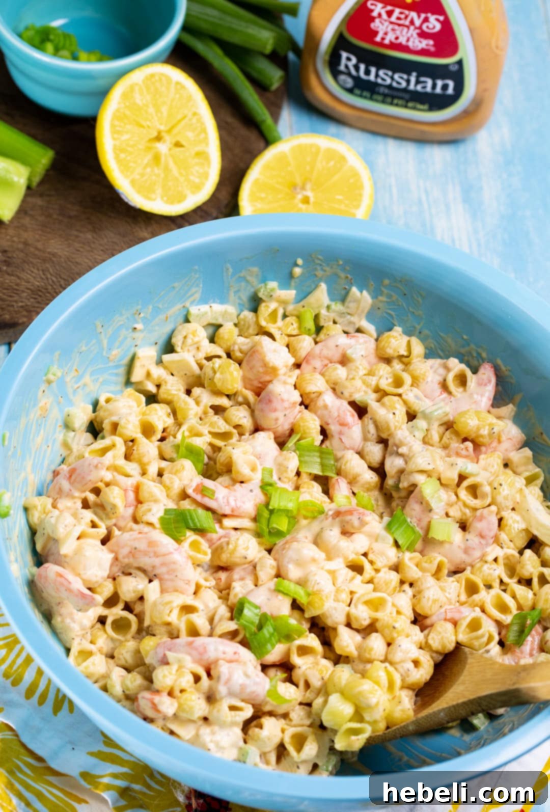 Close-up of shrimp salad in a bowl, garnished with fresh lemon wedges.