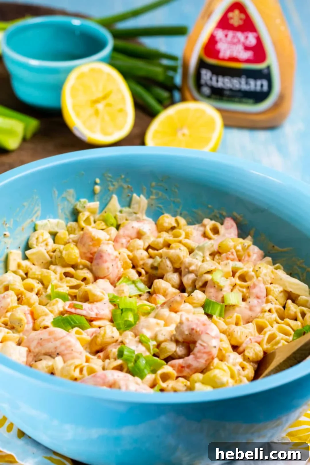 Tangy Shrimp Pasta Salad presented in a blue mixing bowl, ready to be served.