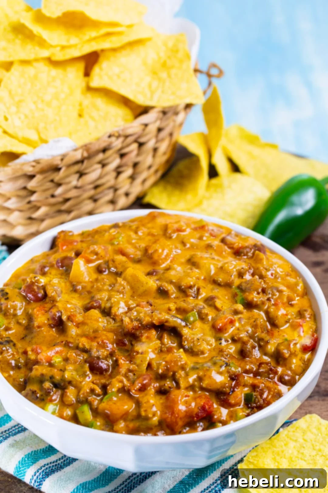 Legendary Chili Cheese Dip 4 Chili Cheese Dip in a bowl and basket full of chips.