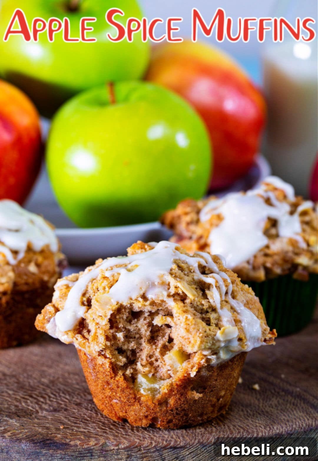 A delectable Apple Spice Muffin with a bite taken out, revealing its moist interior and apple pieces.