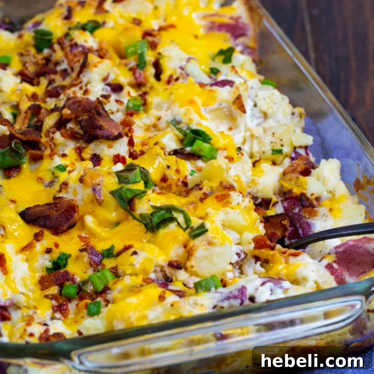 Loaded Smashed Potato Casserole in a baking dish, perfectly golden and bubbly, with a rustic, home-cooked appeal.