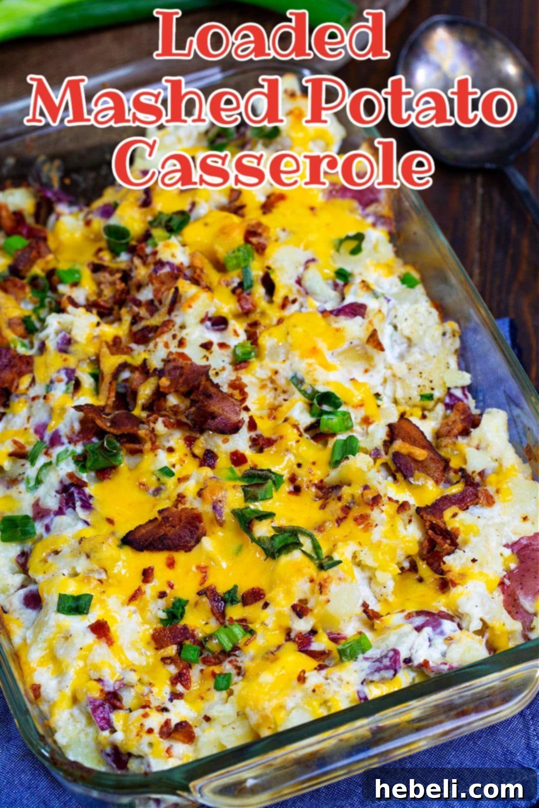 Close-up of potato casserole in a 9x13-inch baking dish, showcasing its irresistible cheesy topping and creamy texture.