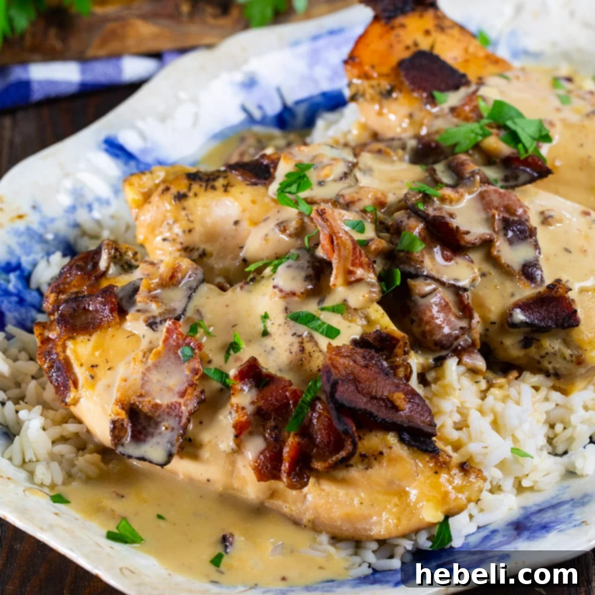 Slow Cooker Chicken with Bacon Gravy served generously over fluffy white rice, ready to be enjoyed as a hearty meal.