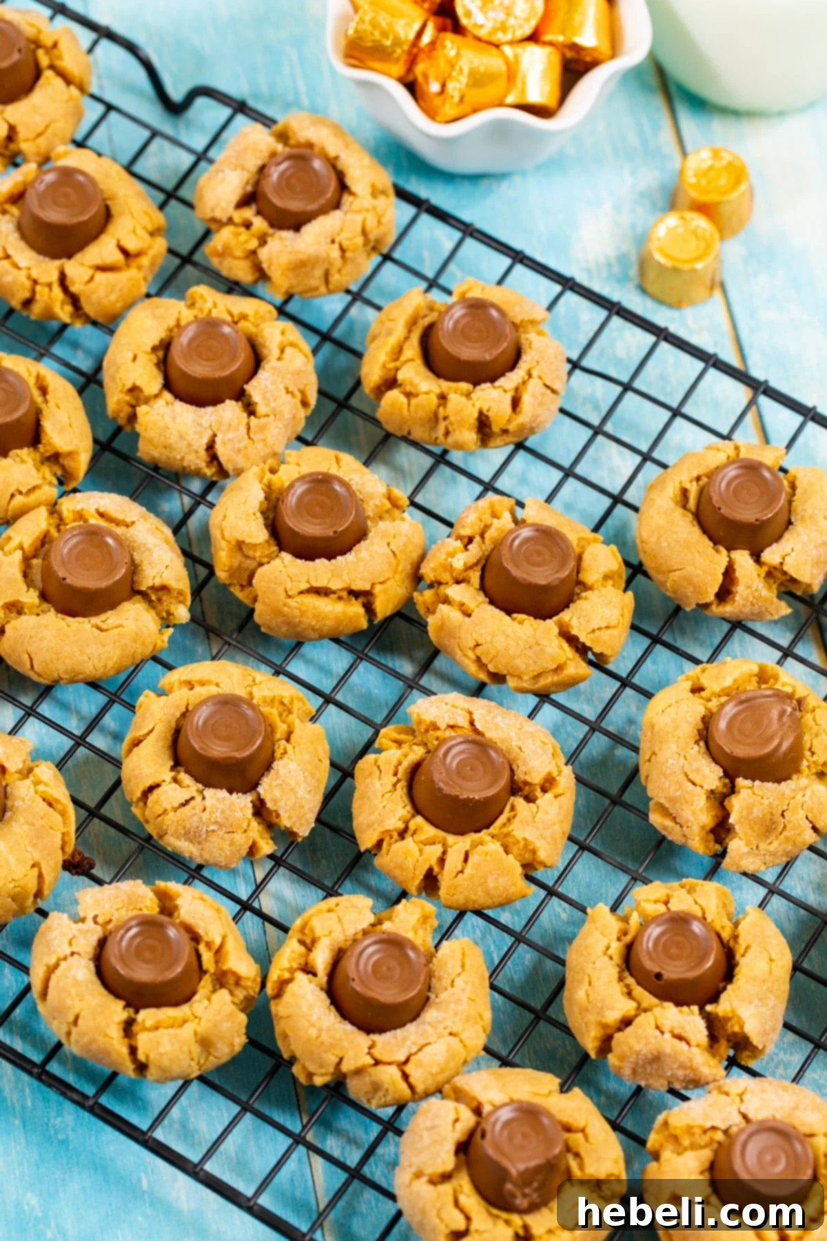 Chewy Caramel Chocolate Blossoms 3 Freshly baked Rolo Blossom Cookies cooling on a wire rack after being removed from the oven.