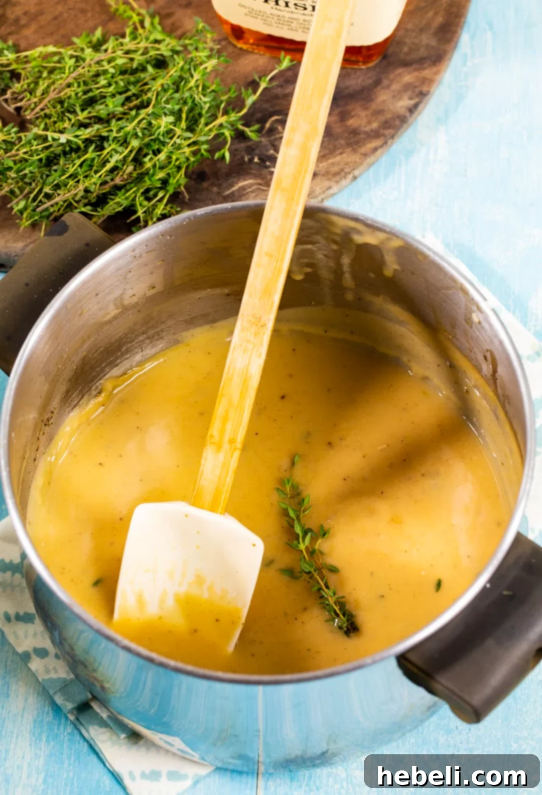 Rich Bourbon Gravy 3 Smooth, simmering Bourbon Gravy in a stainless steel saucepan on the stovetop.