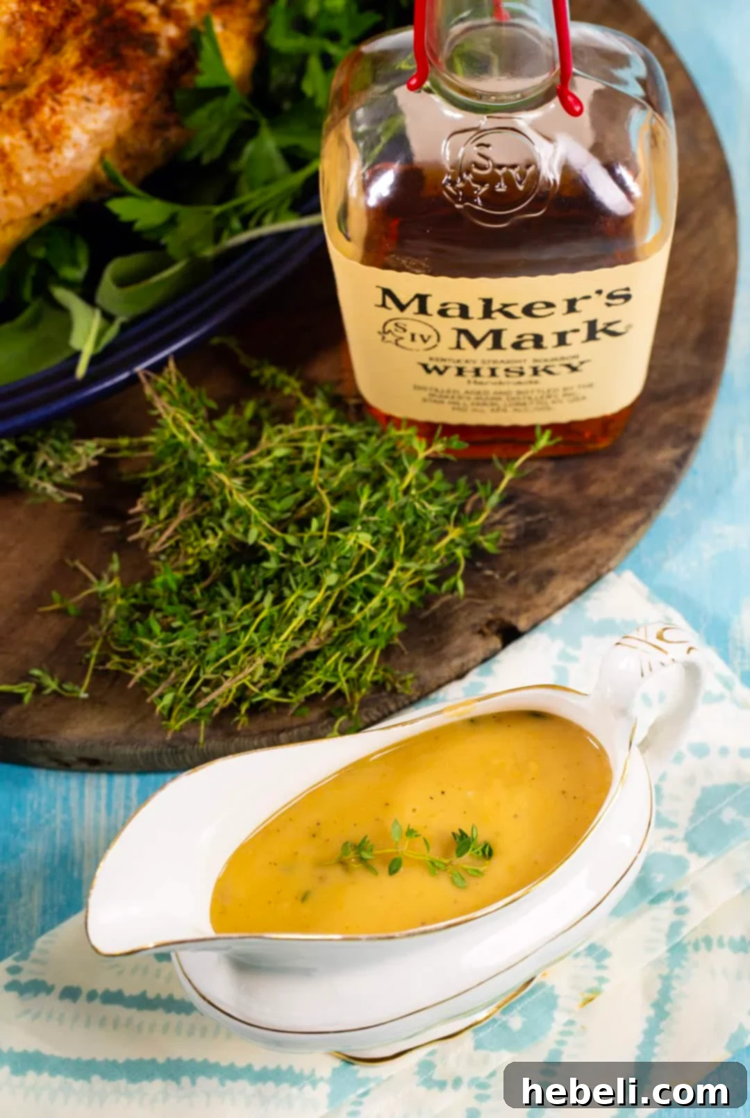 Rich Bourbon Gravy 4 A gravy boat filled with rich Bourbon Gravy, surrounded by a festive holiday spread.