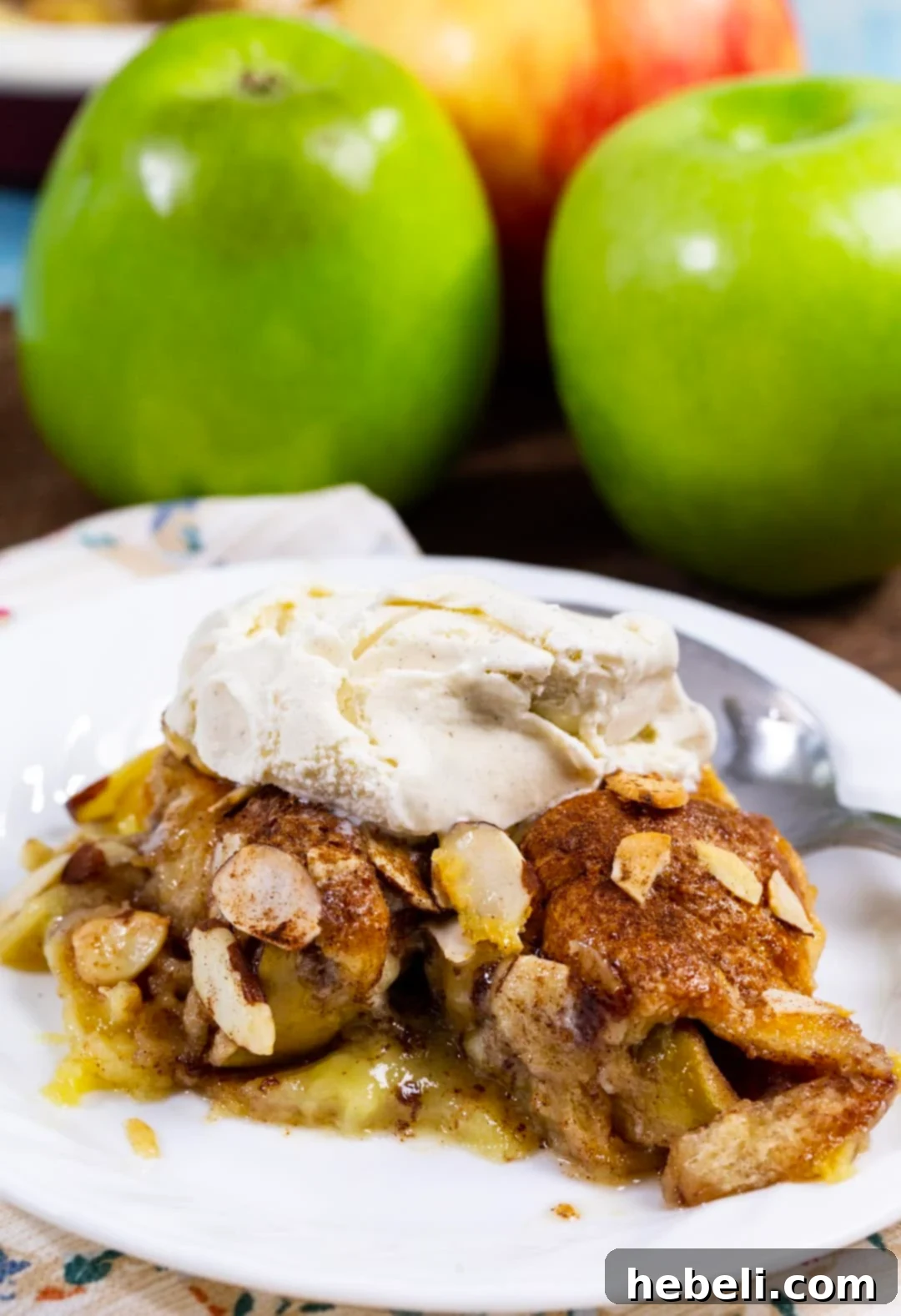 Crescent Apple casserole slice topped with vanilla ice cream.