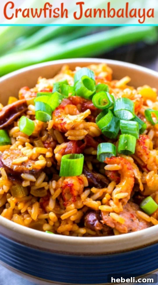 A vibrant bowl of Crawfish Jambalaya garnished with green onions, showcasing a perfect balance of ingredients.