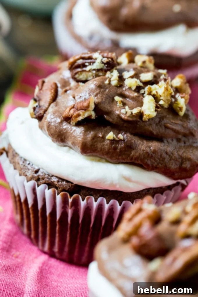 A plate of two finished Mississippi Mud Cupcakes with pecans