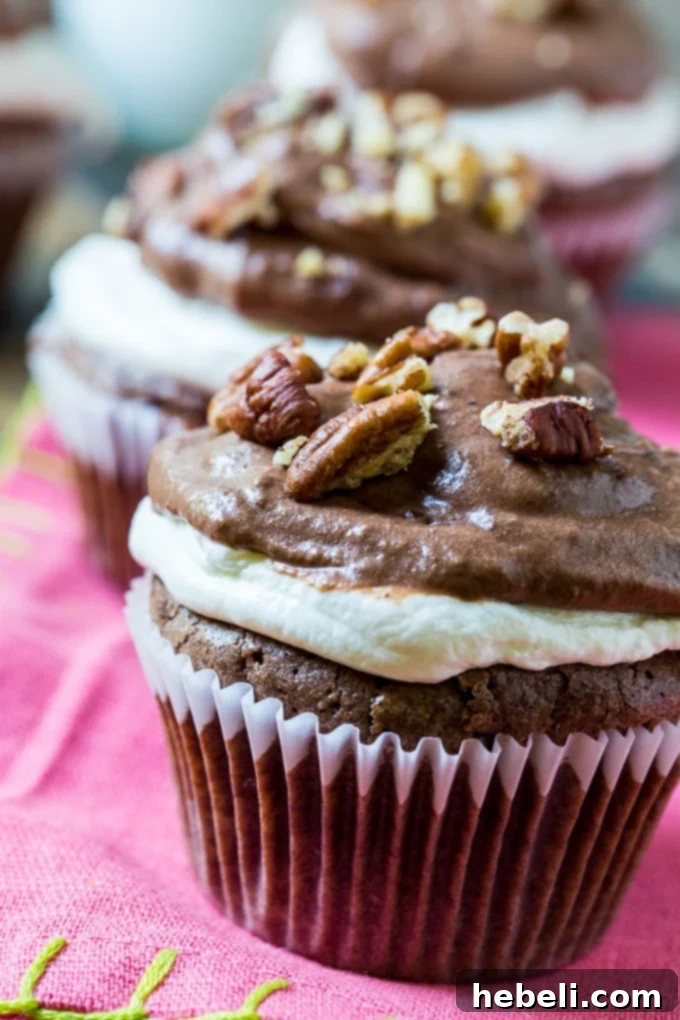 Four Mississippi Mud Cupcakes on a rustic wooden board
