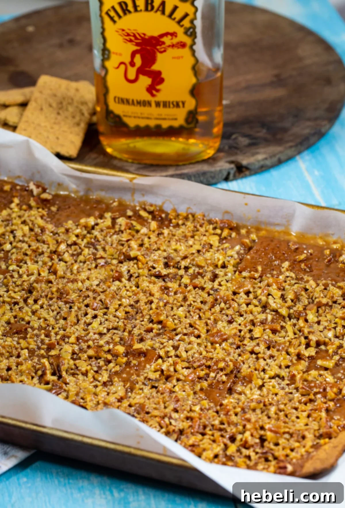 Candy on a rimmed baking sheet just after being removed from oven, glistening with caramel.