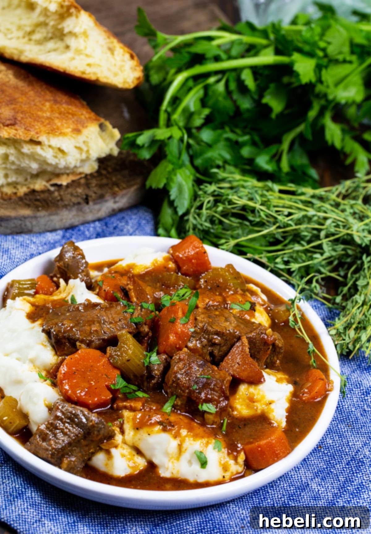 Guinness-Braised Irish Beef Stew 4 A bowl of Irish Guinness Beef Stew artfully plated over creamy mashed potatoes, ready to be enjoyed.