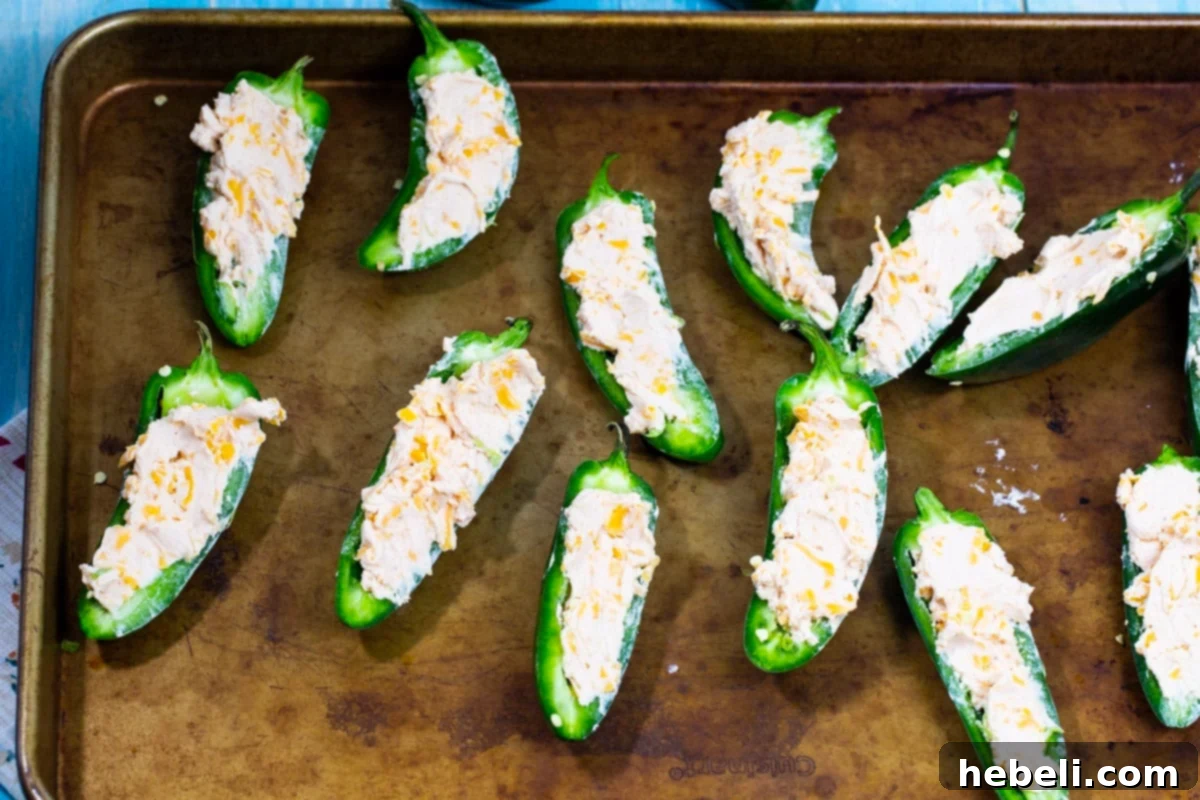 Fresh jalapeno halves generously stuffed with the creamy, cheesy mixture before baking.