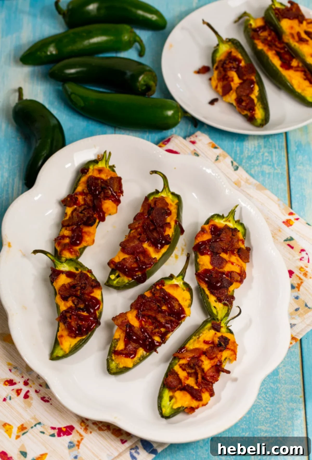 A vibrant platter of freshly baked BBQ Bacon Jalapenos, garnished and ready for serving.