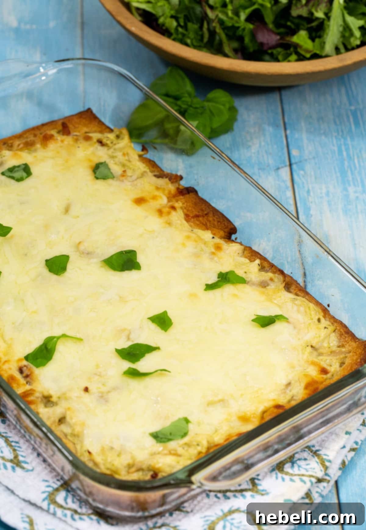 Cheesy Chicken Alfredo Crescent Rolls 3 The Chicken Alfredo Crescent Bake, fresh out of the oven in a baking pan, golden and bubbling.