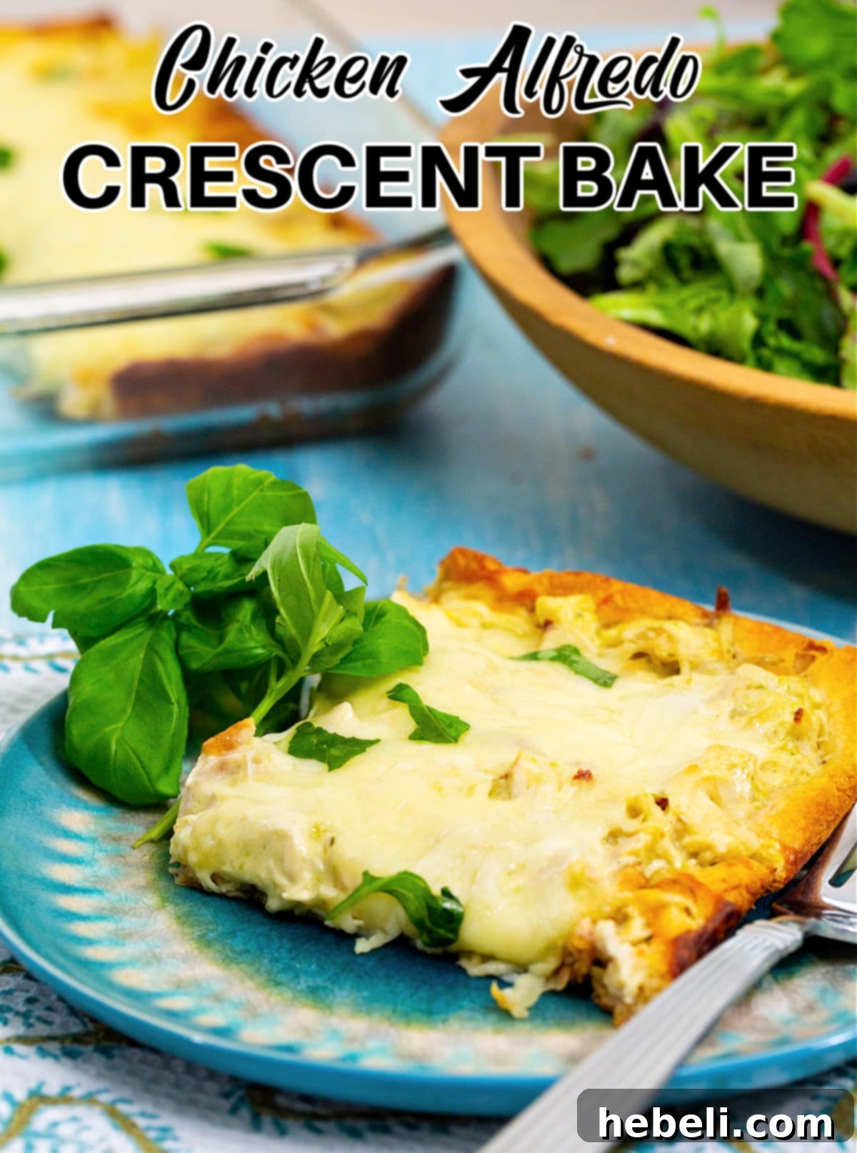 Cheesy Chicken Alfredo Crescent Rolls 5 A perfectly portioned slice of Chicken Alfredo Crescent Bake on a plate, garnished with fresh basil.