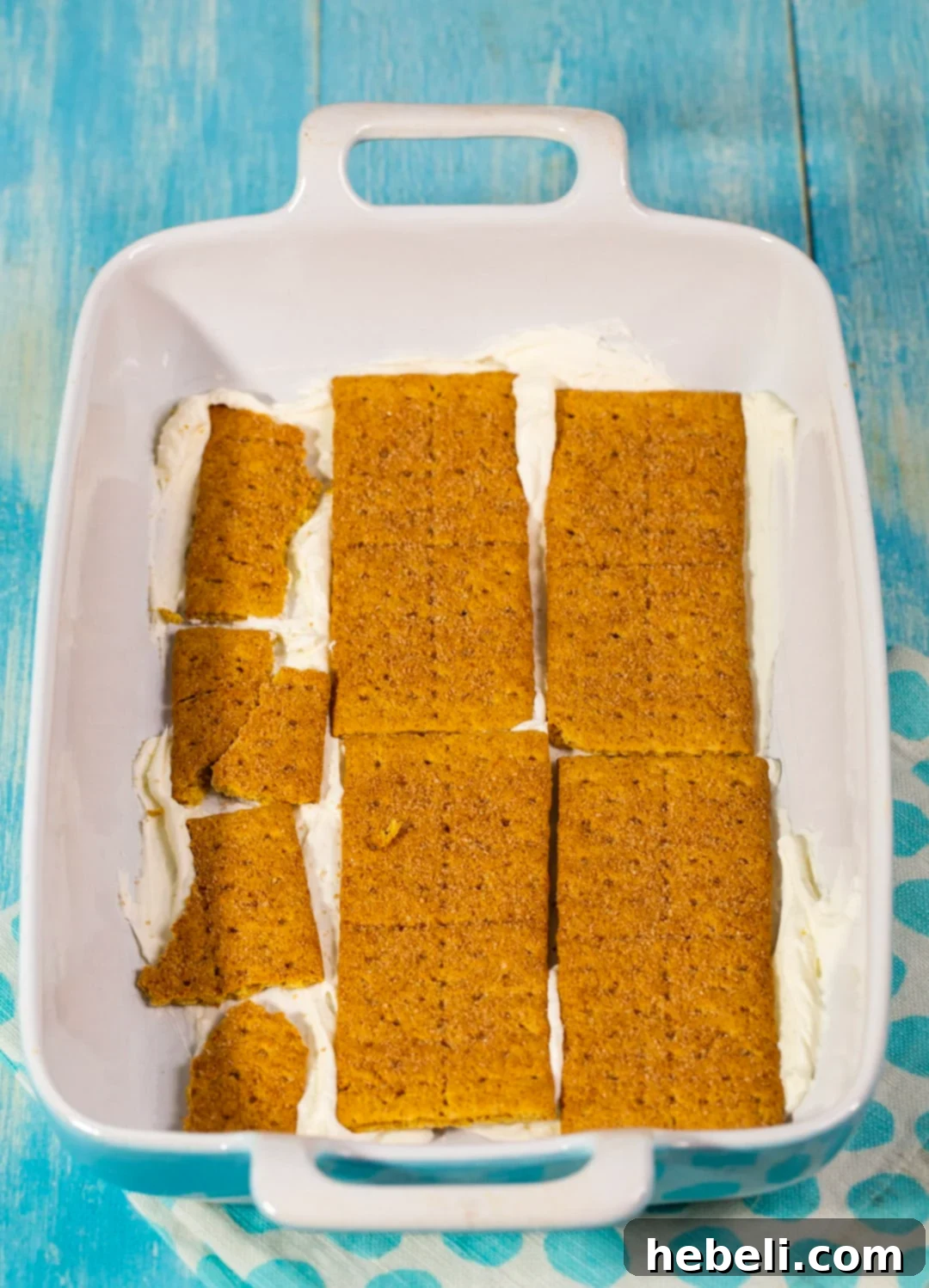 A close-up view of the layers in a Strawberry Icebox Dessert, highlighting graham crackers and creamy filling.