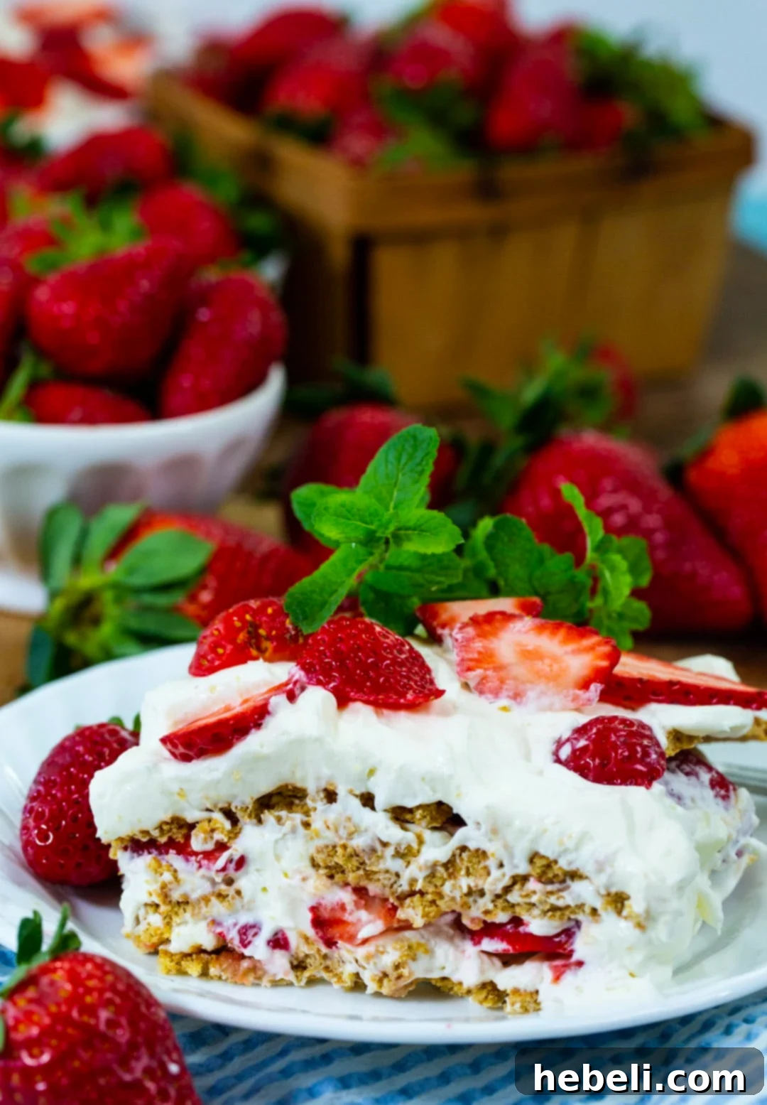 A close-up, tempting view of a single slice of Strawberry Icebox Dessert on a plate, ready to be enjoyed.