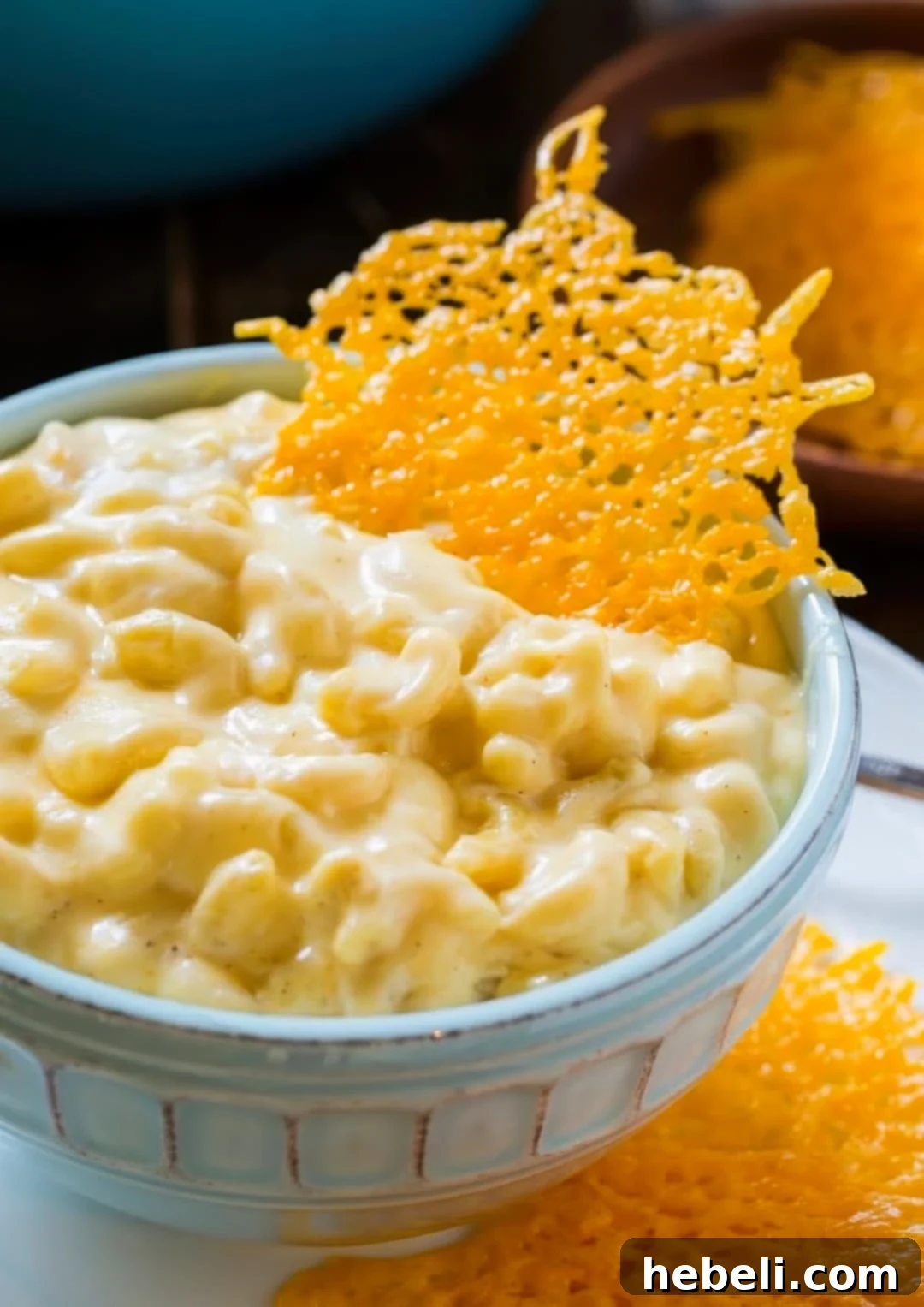 Stovetop Mac with Cheesy Crunch 2 Close-up of a serving of Stovetop Mac and Cheese, garnished with several cheese crisps, showcasing its rich texture.