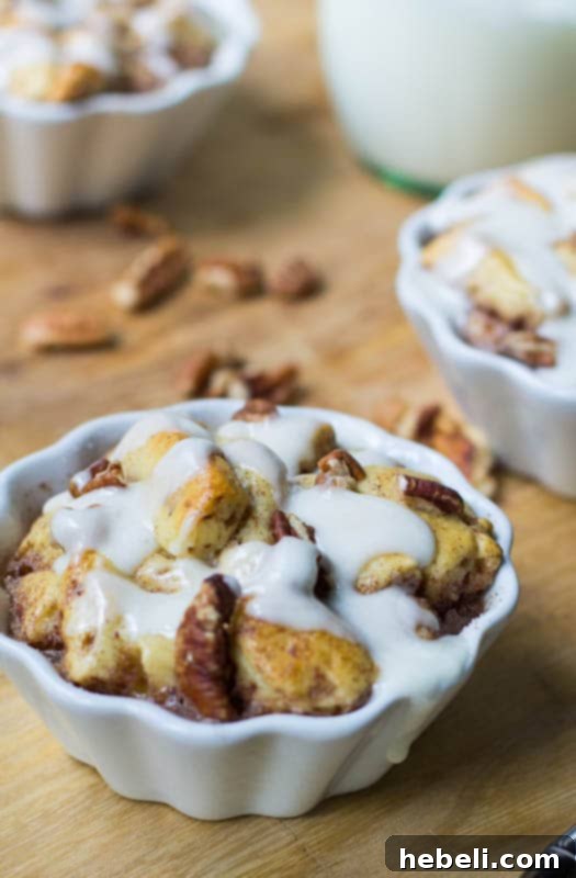 Decadent Cinnamon Roll Bread Pudding 3 A serving of Cinnamon Roll Bread Pudding glistening with a sweet glaze and sprinkled with pecans.