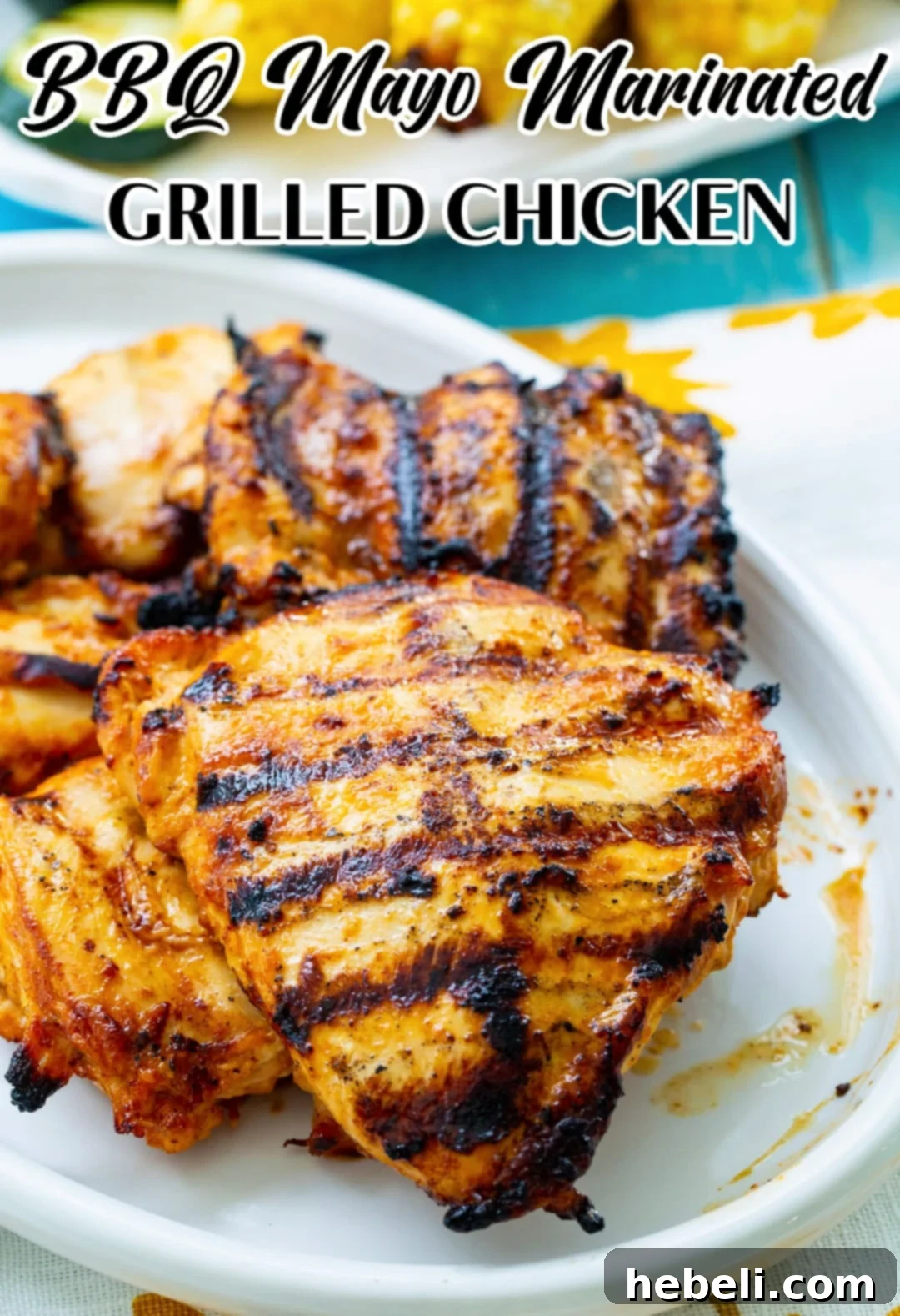 Smoky Tangy Grilled Chicken 6 BBQ Mayo Marinated Grilled Chicken beautifully plated, garnished and ready for serving, possibly with a side dish blurred in the background.