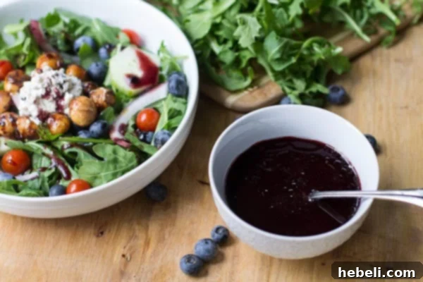 Bowl of Blueberry Vinaigrette next to bowl of salad.