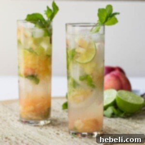 A refreshing Nectarine Mojito garnished with a lime wedge and mint sprig.