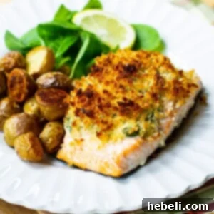 Baked Salmon Stuffed with Mascarpone Spinach, a close-up of a single serving with the crispy topping and creamy filling visible.