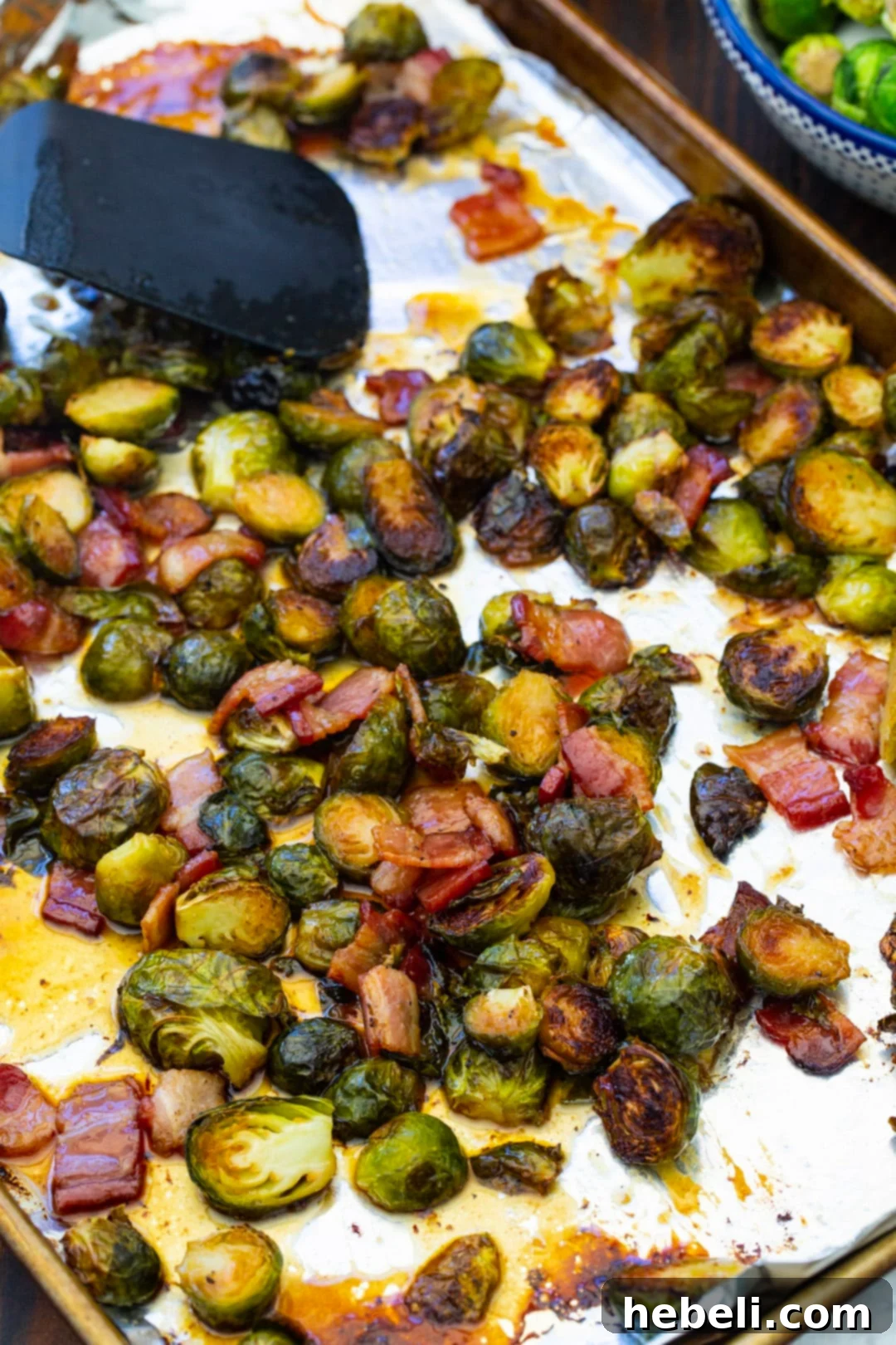 Glazed Brussels sprouts on a baking sheet, fresh out of the oven.