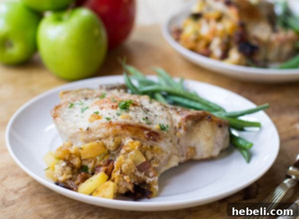 Pork Chops Stuffed with Apples and Bacon on a plate with green beans.