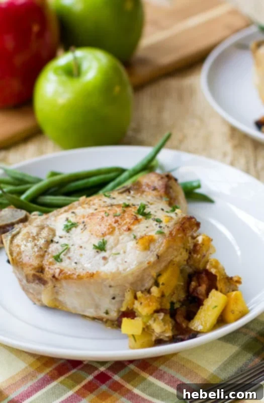 Apple-Bacon Stuffed Pork Chop on a plate with green beans.