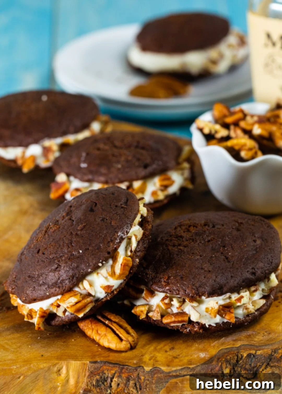 A rustic wooden cutting board artfully displaying freshly baked Whiskey Whoopie Pies, ready for enjoyment.