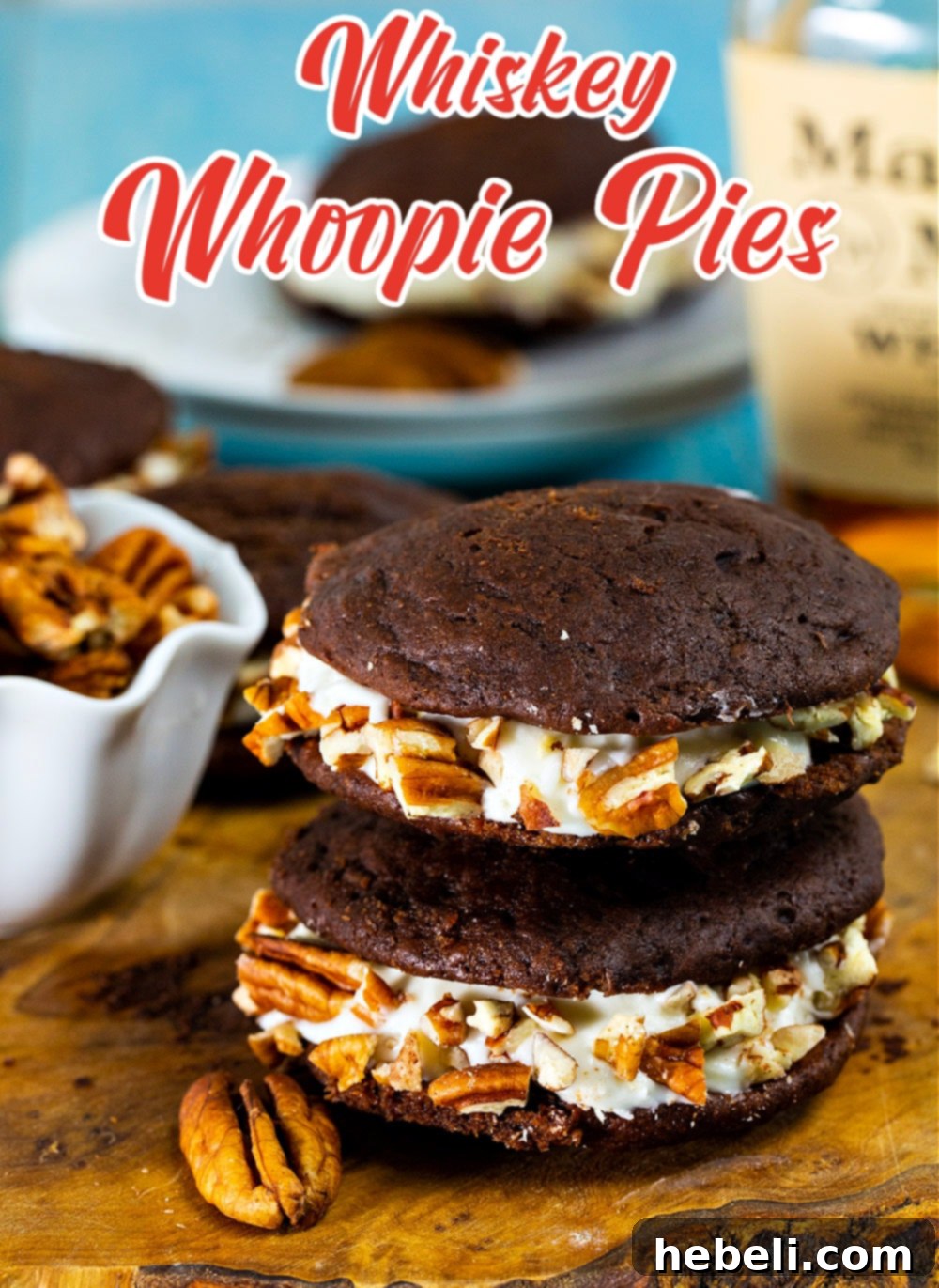 A delightful stack of Whiskey Whoopie Pies arranged elegantly on a wooden cutting board, poised for serving and enjoyment.