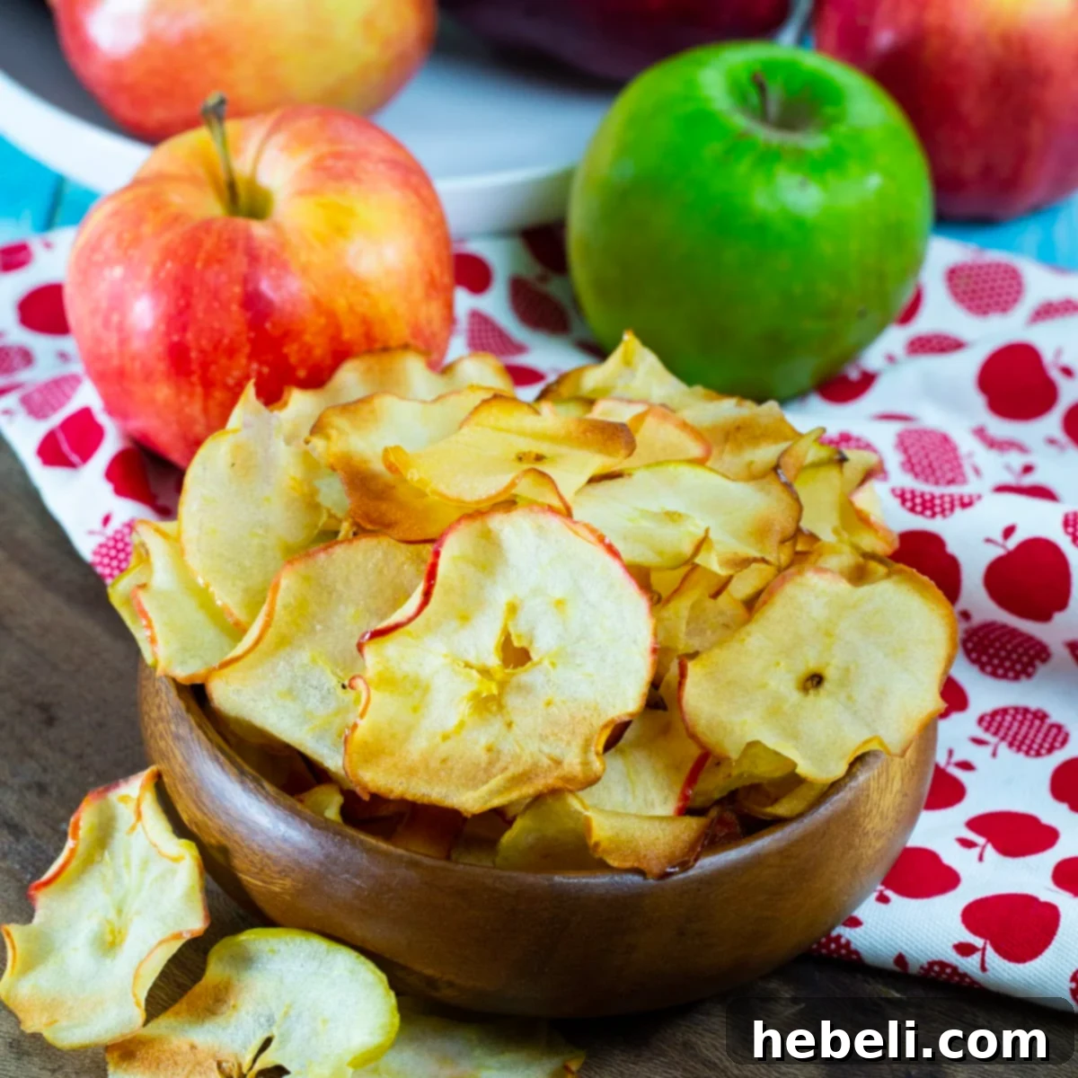 Bowl full of golden-brown Caramelized Apple Chips, ready to be enjoyed.
