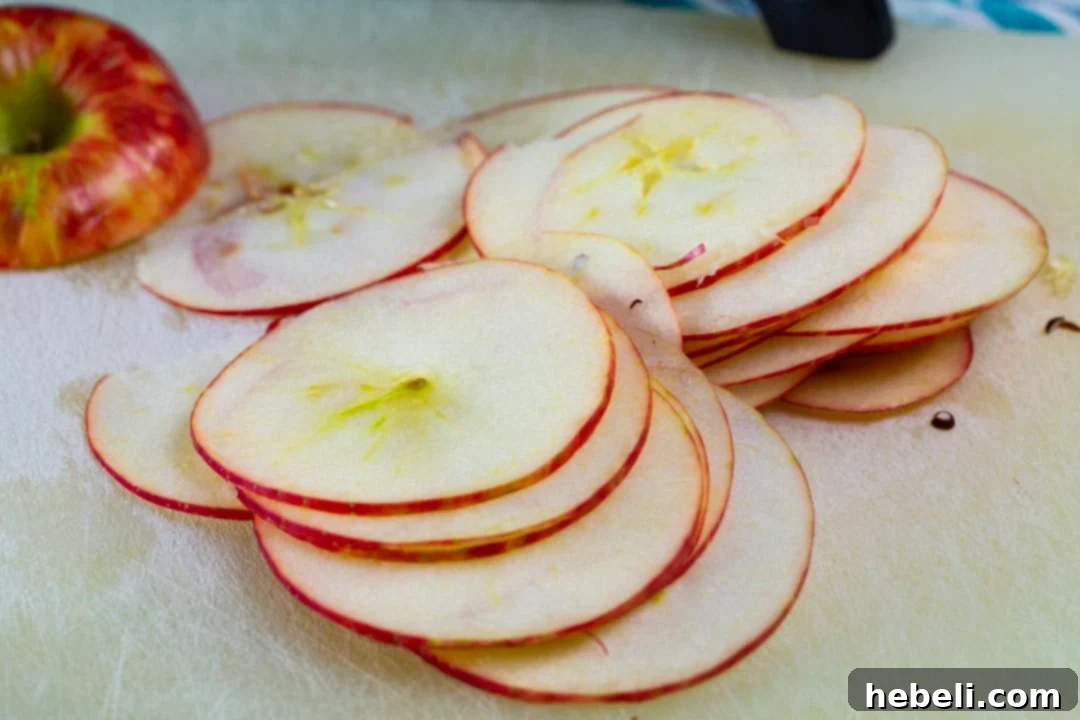 Perfectly thin, fresh apple slices prepared for caramelization.