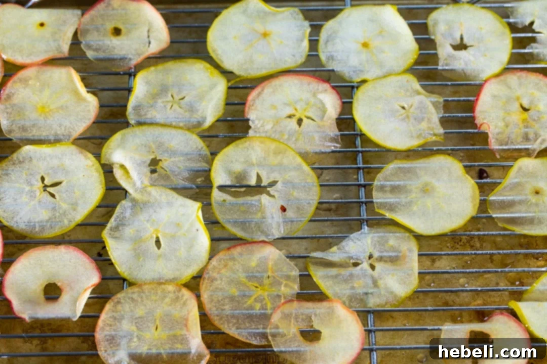 Thin apple slices glistening after simmering in sugar syrup.