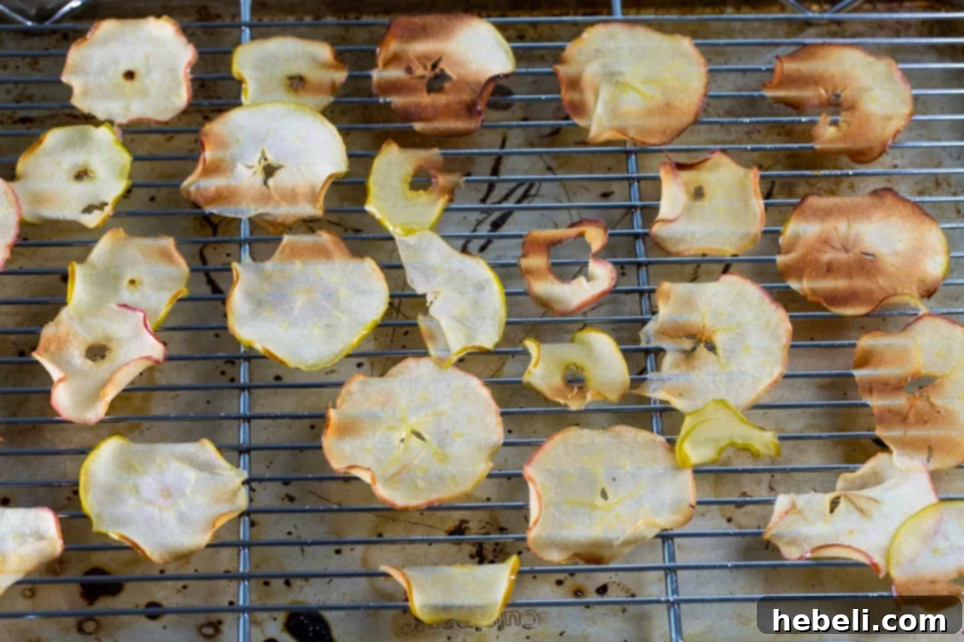 Baked caramelized apple slices on a cooling rack.