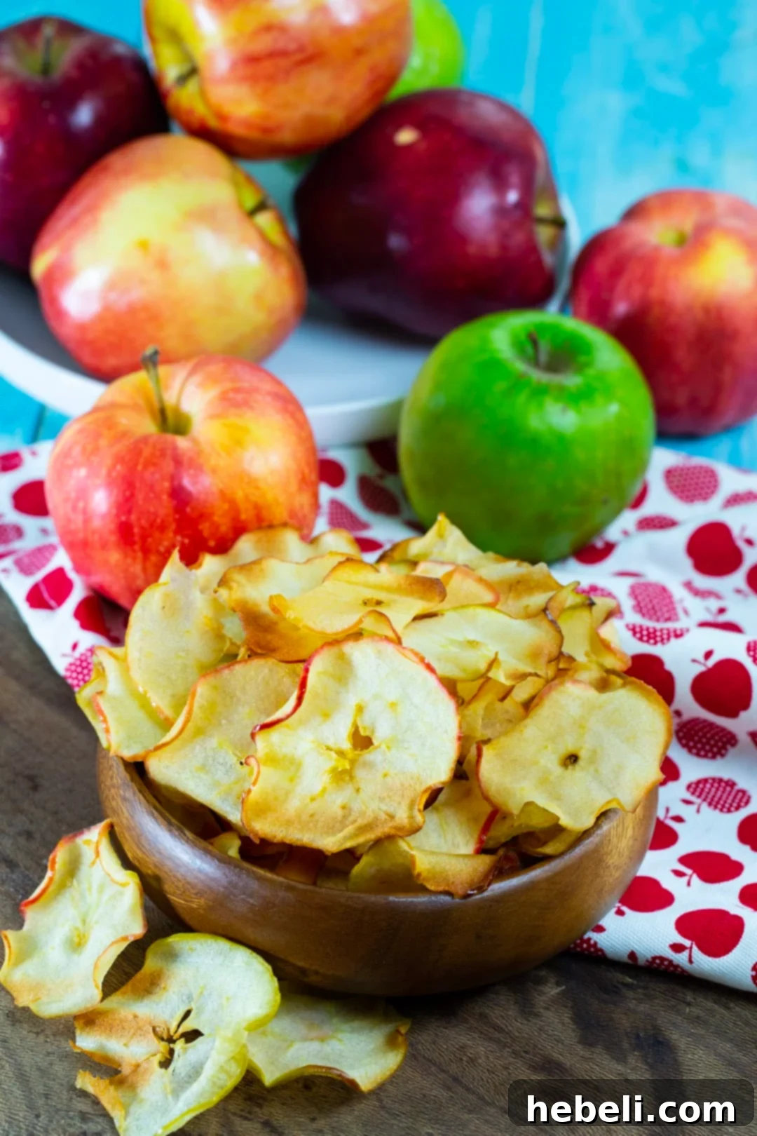 Caramelized Apple Chips in a rustic bowl, surrounded by fresh apples.