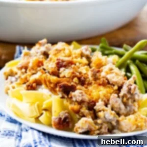 Sandy's Chicken (Chicken with Stuffing and Cheese) over egg noodles with a side of green beans.