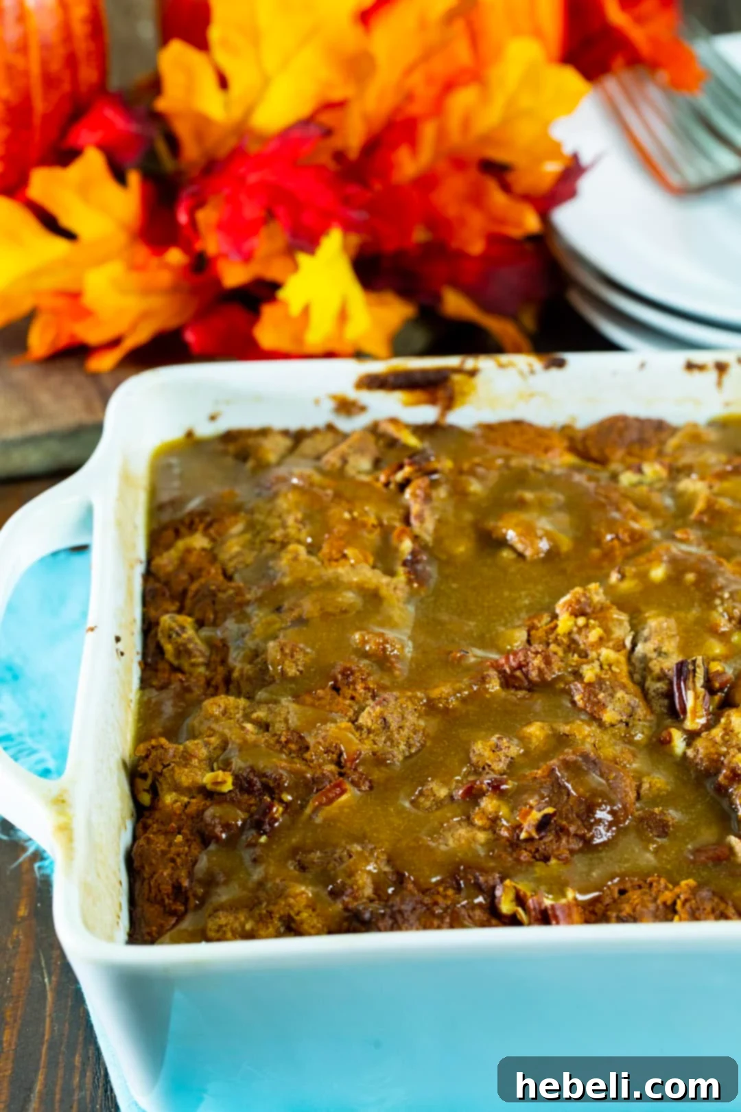 Close-up of baked Pumpkin Coffee Cake with Brown Sugar Glaze, still in the baking dish, showing the beautiful drizzle.