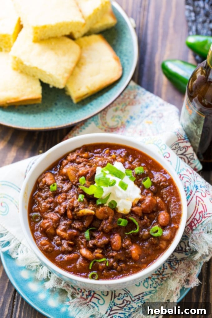 Inferno Chili Recipe 4 A bowl of Five-Alarm Chili garnished with fresh avocado, sour cream, and cilantro