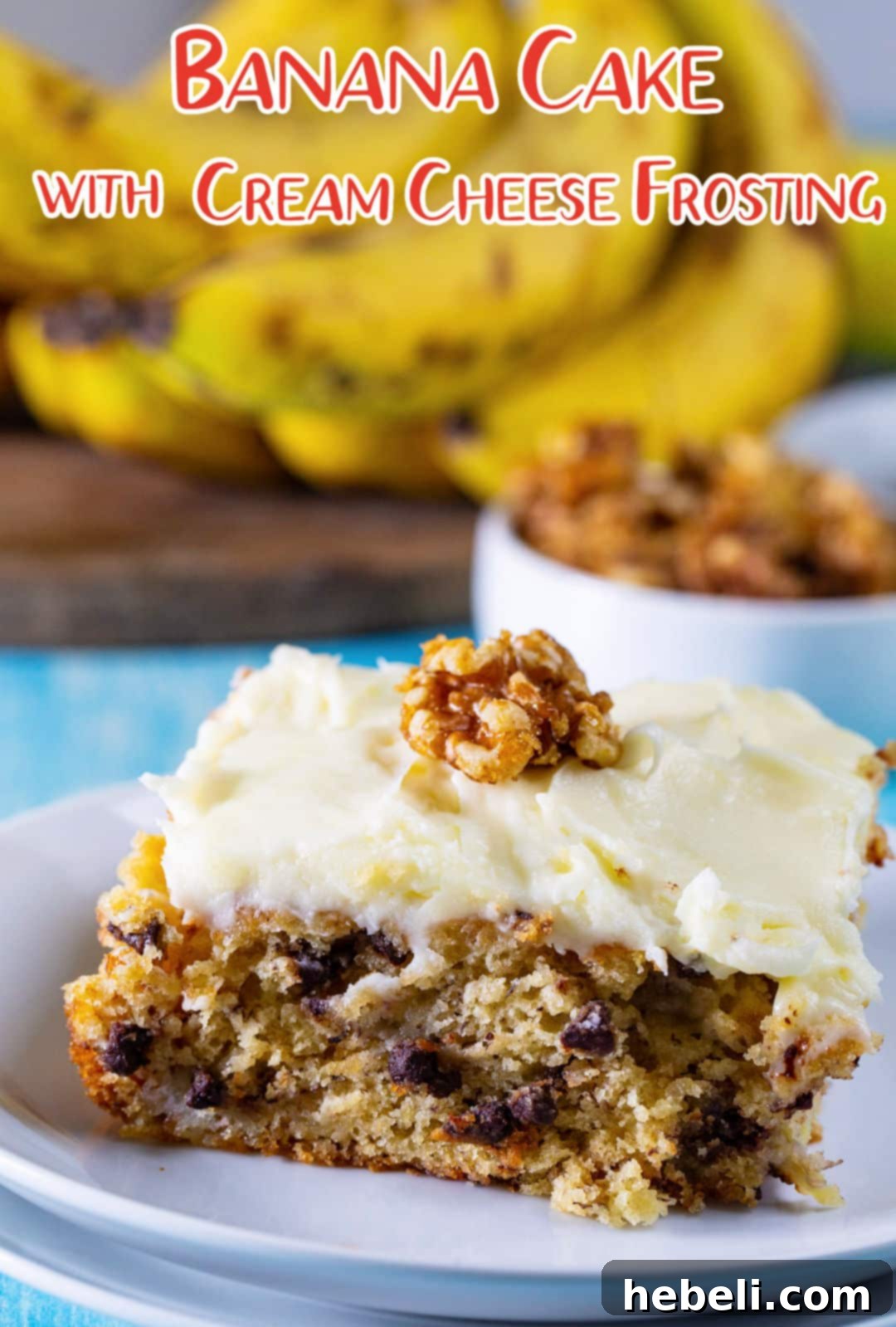 An entire Banana Cake with Cream Cheese Frosting and sugared walnuts in a baking dish, showcasing its generous size and beautiful presentation.