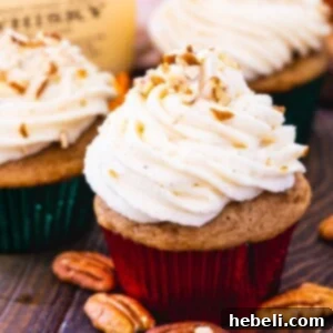 Bourbon and Spice Cupcakes surrounded by pecan halves.