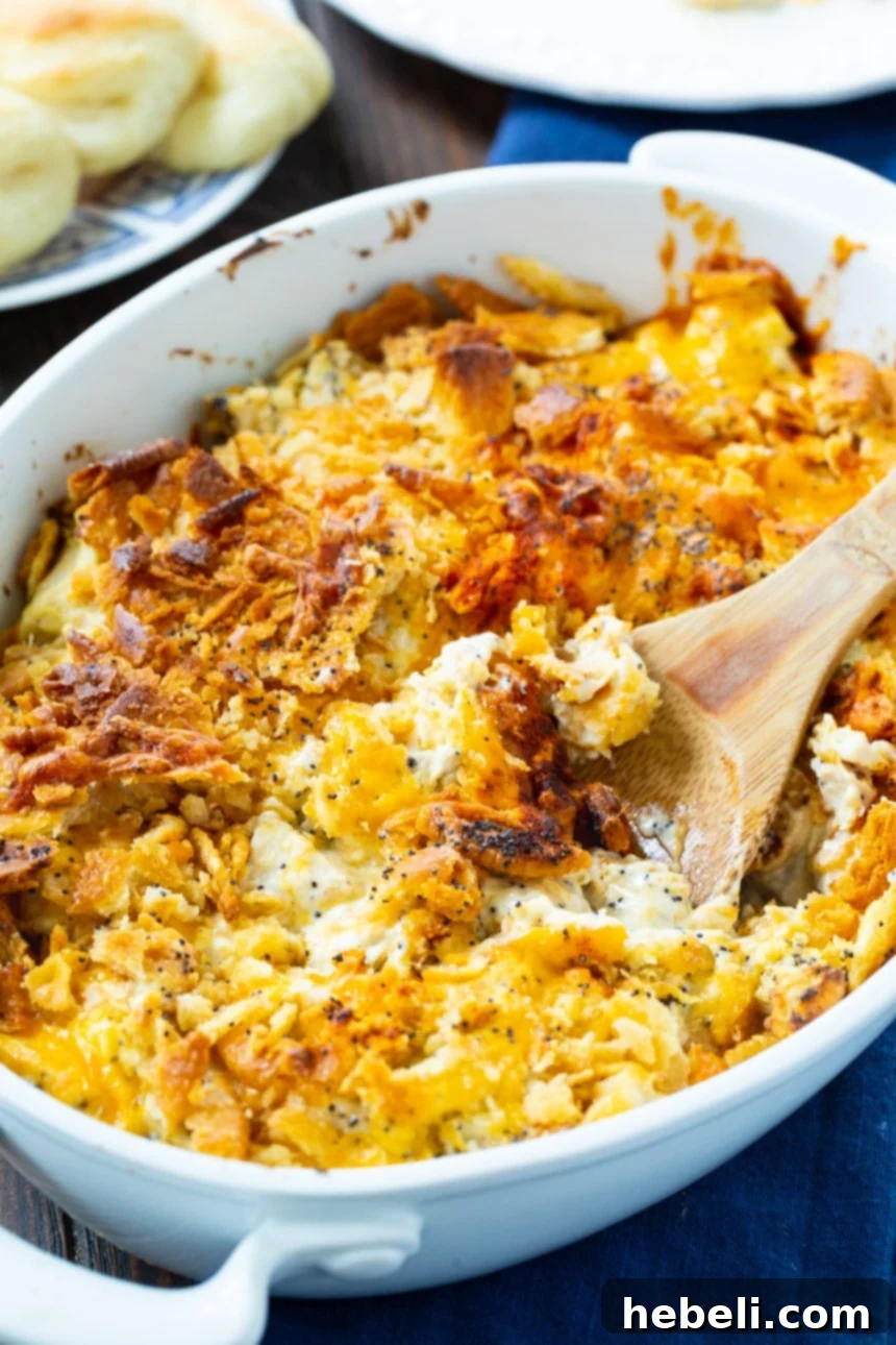 Classic Poppy Seed Chicken Casserole 3 Poppy Seed Chicken Casserole served in an elegant oval casserole dish, showcasing its creamy interior and golden topping.
