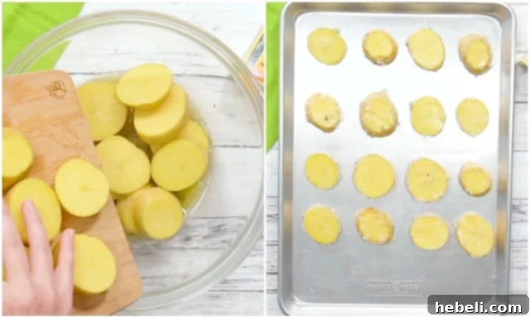 Freshly sliced potatoes being tossed in a bowl with the melted butter, thyme, salt, and pepper mixture before being spread onto a baking sheet.
