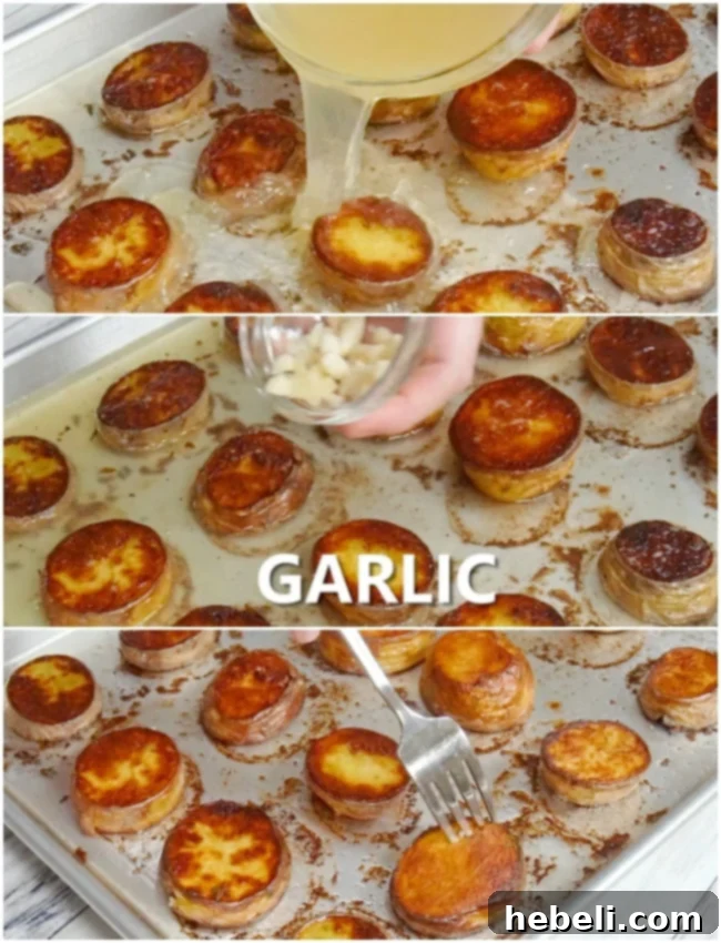 Chicken broth being poured over partially roasted potato slices in a baking pan, with whole garlic cloves nestled among them, ready for the final cooking stage.