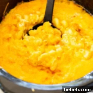 A vibrant, close-up image of Trisha Yearwood's Slow Cooker Mac and Cheese in a crockpot, highlighting its golden crust and creamy texture.