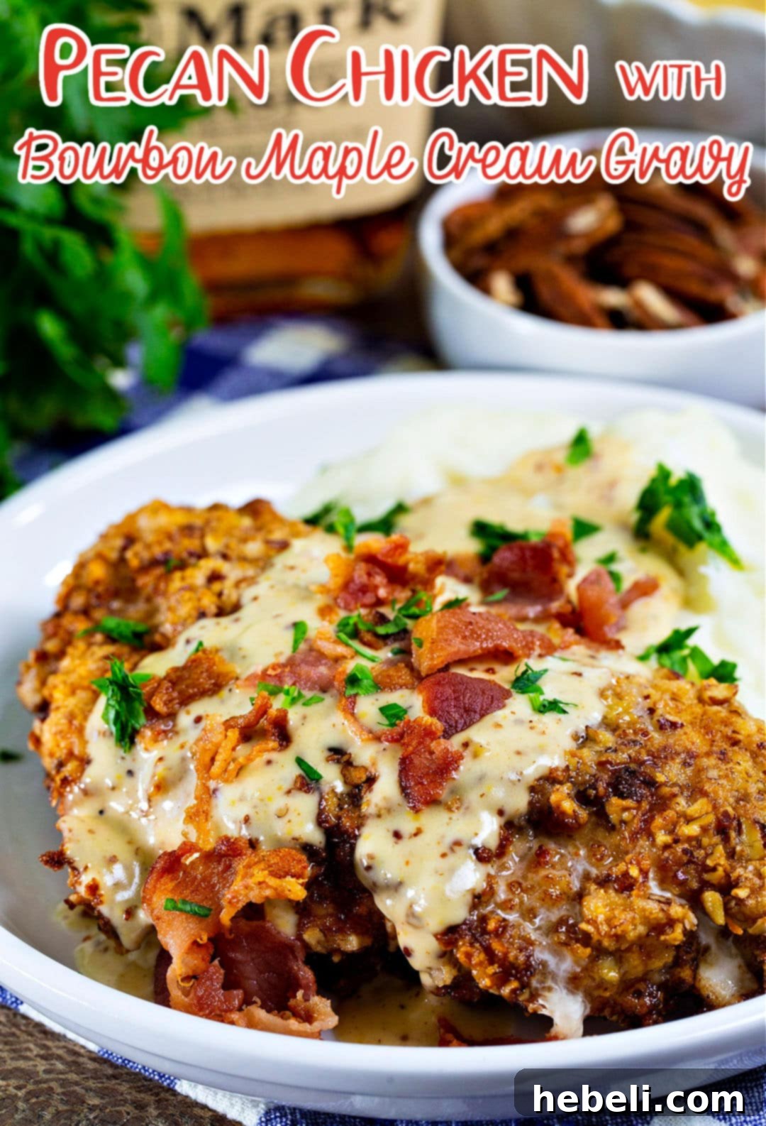 Pecan chicken covered in gravy and bacon crumbles, close-up.