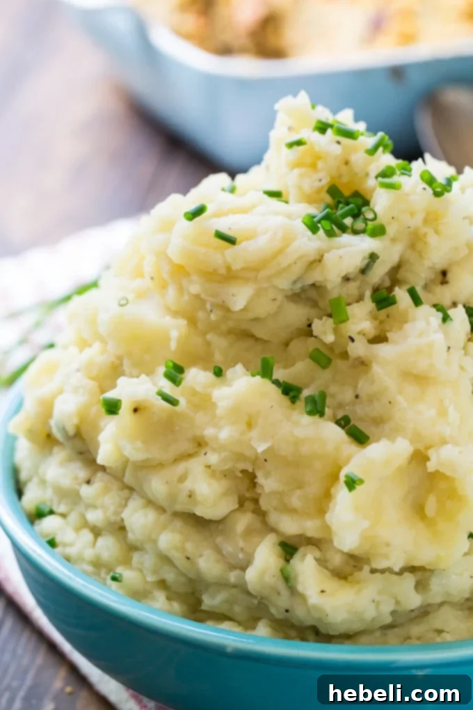 A close-up shot of perfectly textured, rich Crock Pot Mashed Potatoes, capturing their inviting warmth and deliciousness.